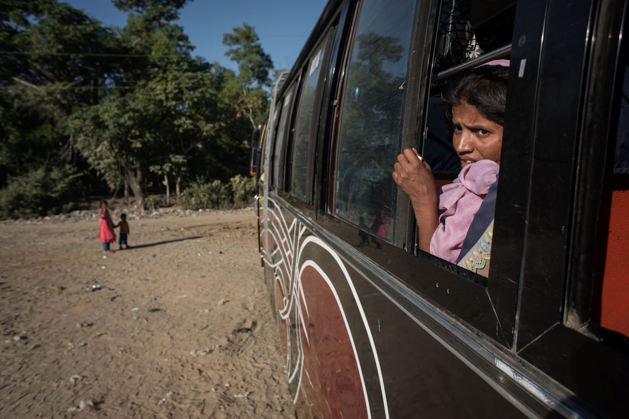 A Rohingya sits aboard a bus leaving for a refugee camp after arriving from Myanmar, near Shah Barir Dip at Cox's Bazar on December 3, 2017.