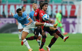 Sandro Tonali (R) in action for AC Milan.