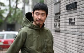 (FILES) Hong Kong actor Gregory Wong (R) enters the West Kowloon court in Hong Kong on February 1, 2024. Twelve Hong Kongers were jailed on March 16, 2024 for up to seven years over the storming of the city's legislature in 2019 at the height of pro-democracy protests that challenged the Beijing-backed government. (Photo by Peter PARKS / AFP)