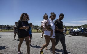 Parents and students leave the scene after being reunited following a shooting took place at Apalachee High School in Winder, Georgia, on 4 September 2024.