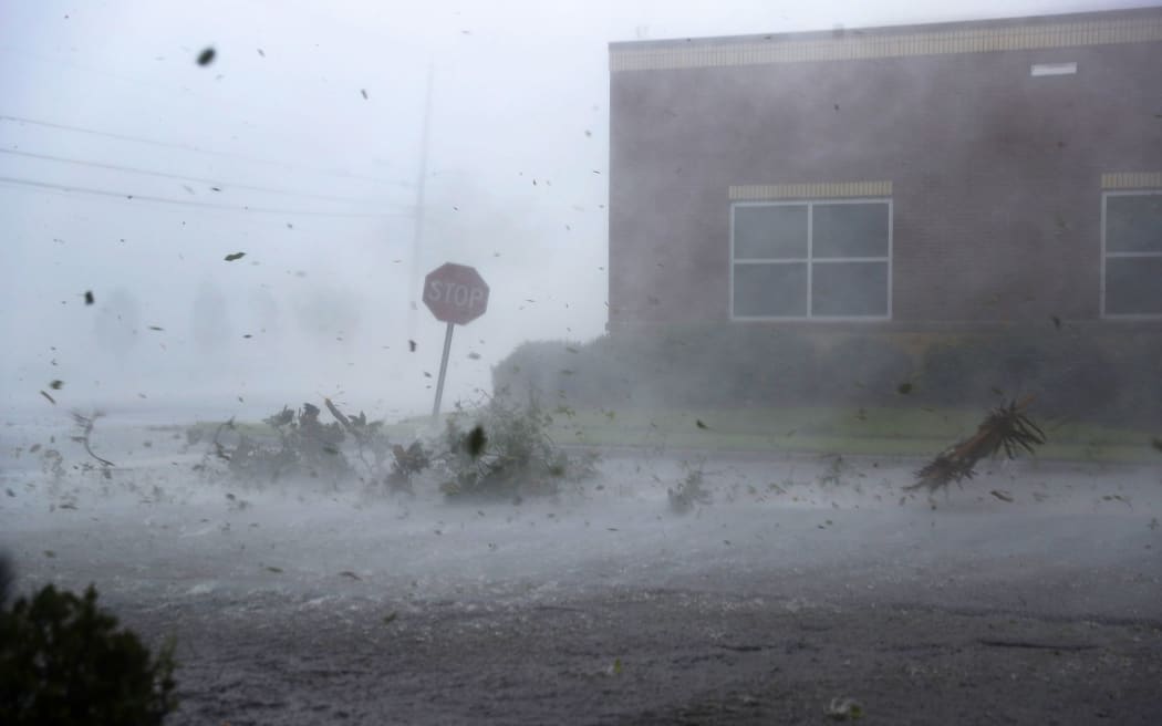 Debris is blown down a street by Hurricane Michael in Panama City, Florida.