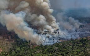 Smoke billowing from forest fires in the municipality of Candeias do Jamari, close to Porto Velho in Rondonia State, Brazil, 24 August 2019.