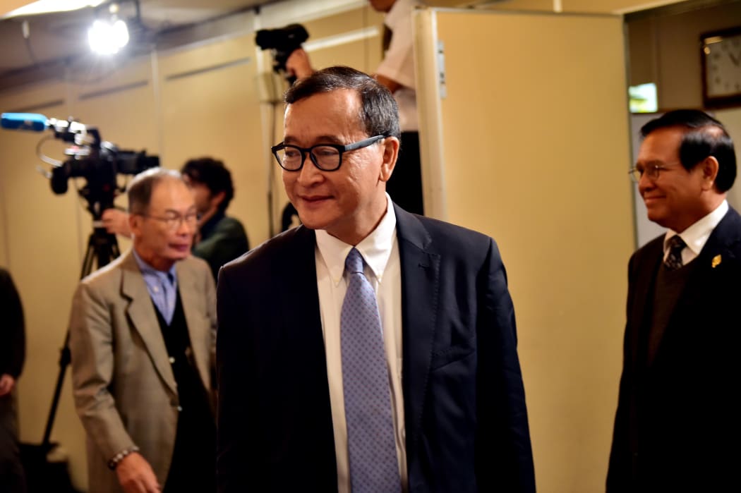Cambodia's main opposition Cambodia National Rescue Party president Sam Rainsy arrives at a conference room to speak to the press in Tokyo.