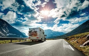 Caravan car travels on the highway.