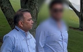 Hamilton dentist Rahul Gautam, left, leaves the Hamilton District Court.