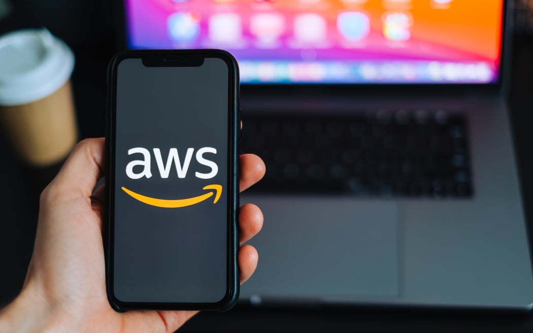Amazon Web Services logo on the smartphone screen.