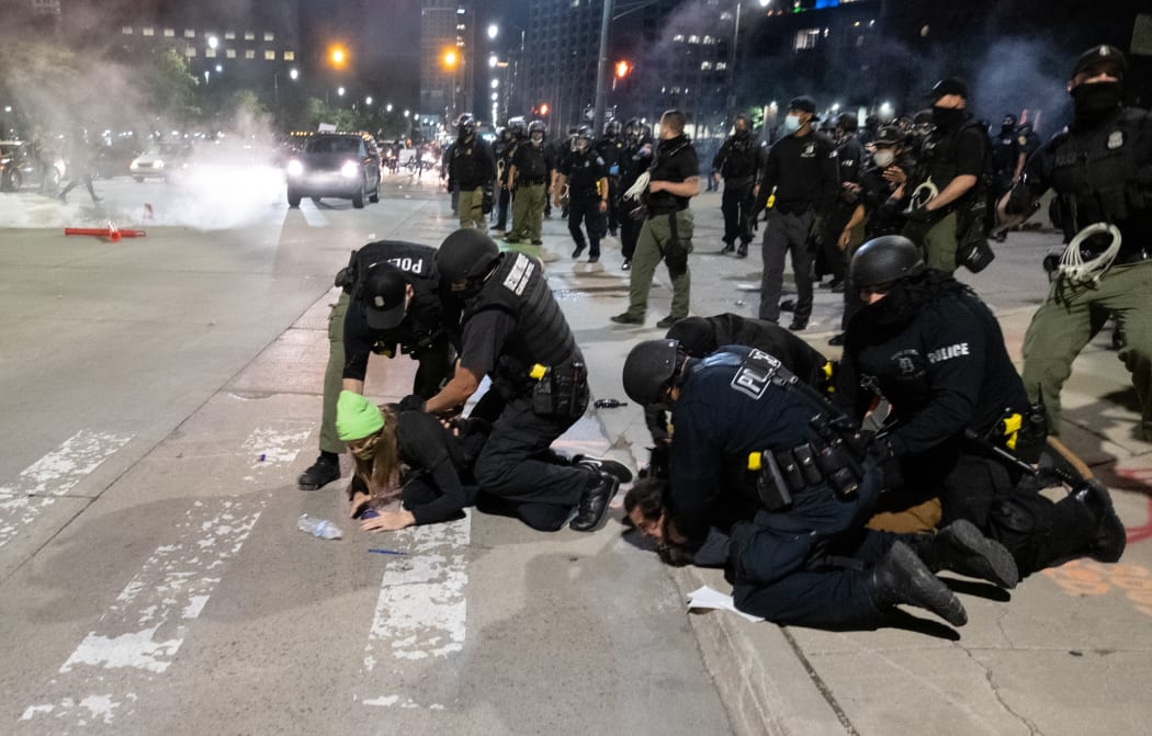 Detroit Police arrest a protester near the Detroit Police station, as protesters march through the streets of Detroit, Michigan for a second night.