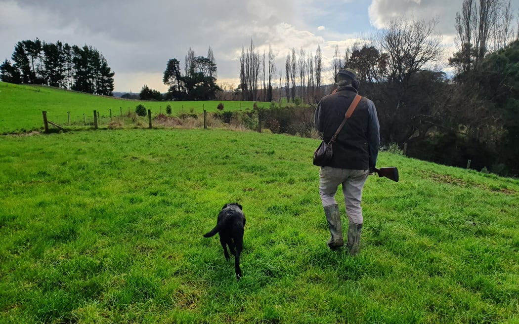 A duck shooter and his dog