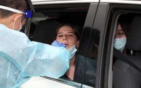 A health official takes samples for Covid-19 tests from residents of the northern beaches in Sydney on 20 December 2020.