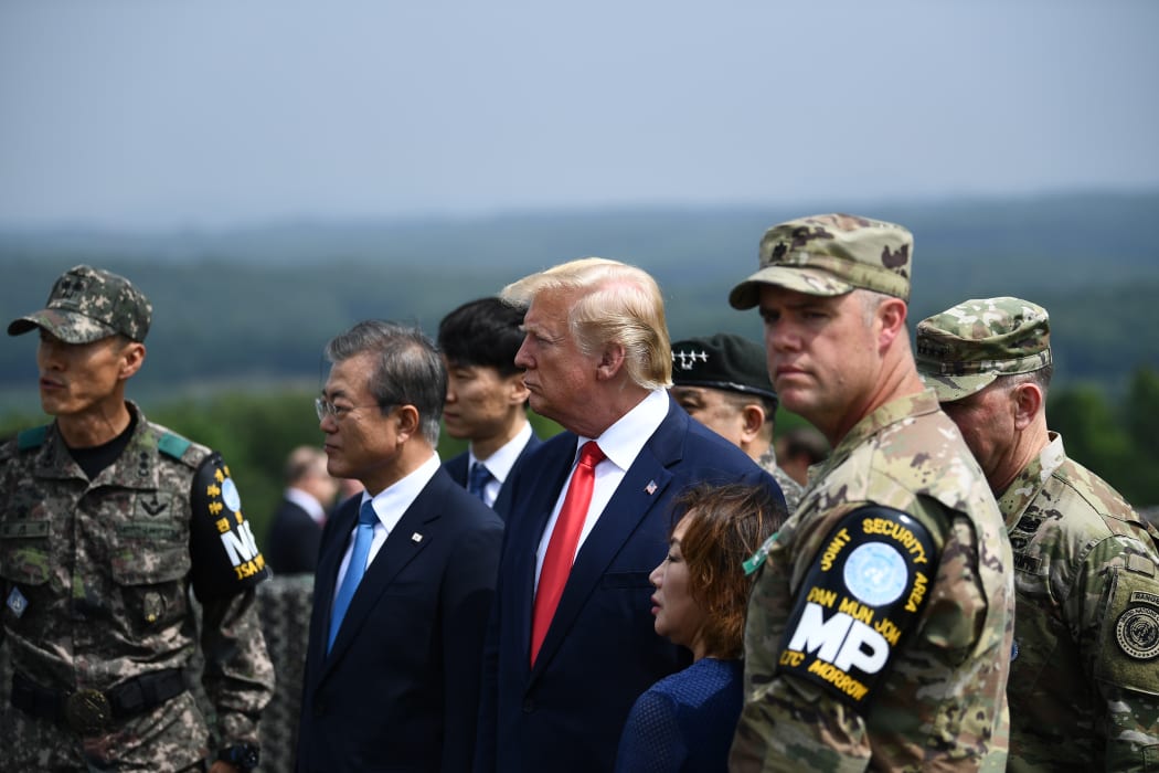 US President Donald Trump (centre) and South Korean President Moon Jae-in (second from left) visit an observation post in the Joint Security Area at Panmunjom in the Demilitarized Zone separating North and South Korea on June 30, 2019.
