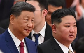 China’s President Xi Jinping (L) and North Korea’s leader Kim Jong Un arrive for a reception in the Great Hall of People, following a military parade marking the 80th anniversary of victory over Japan and the end of World War II, in Beijing on September 3, 2025. (Photo by Jade Gao / AFP)