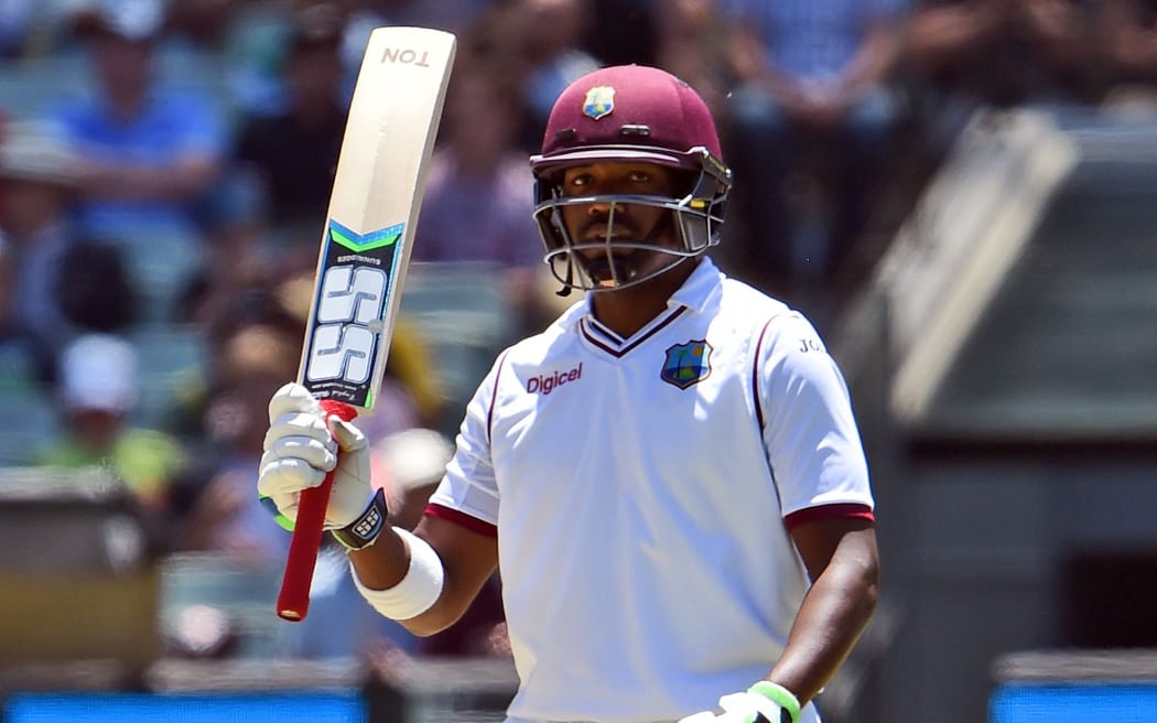 West Indies batsman Darren Bravo acknowledges the applause after scoring his half century against Australia on the third day of the second cricket Test in Melbourne on December 28, 2015. AFP PHOTO / William WEST