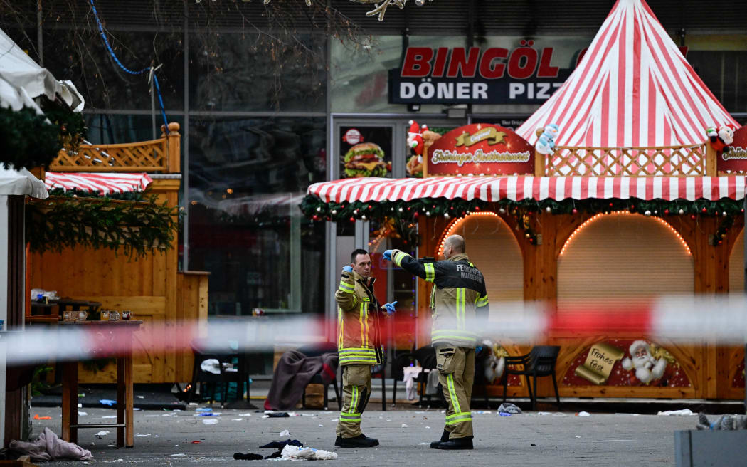Emergency services personnel on 21 December 2024, still working at the Christmas market in Magdeburg city the morning after a car fatally crashed into a crowd.