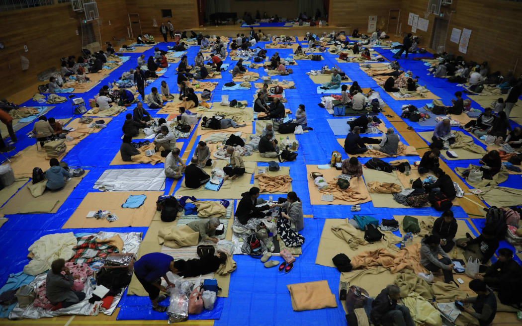 People stay at a shelter as the Chikuma River overflowed in Nagano City, Nagano prefecture on Oct. 13, 2019, one day after Typhoon No. 19, known as Typhoon Hagibis, a powerful super typhoon, made a landfall.