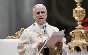 Pope Leo XIV addresses faithfull as he performs the Christmas mass at St Peter's Basilica in the Vatican on December 25, 2025. (Photo by Tiziana FABI / AFP)
