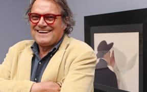 Italian Photographer Oliviero Toscani, in front of his picture "Kissing Nun" at an exhibition entitled "controversy, justice, ethics and photography" in a Vienna gallery, in 2010.