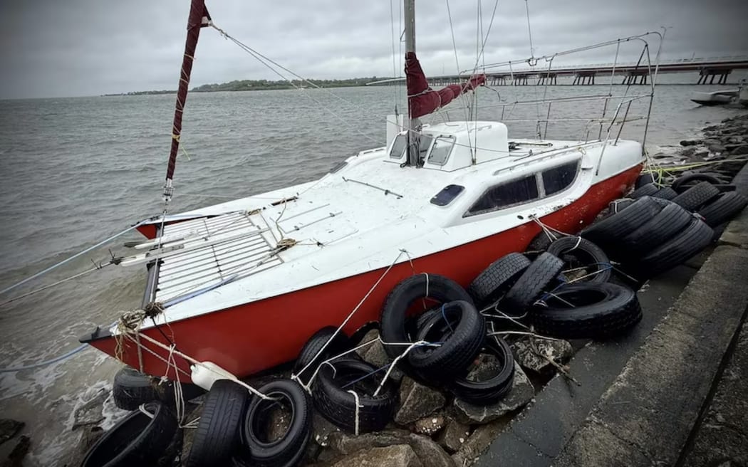 A boat moored on land after ex-Tropical Cyclone Alfred passed through Bribie Island. (ABC News: Tobi Loftus)
