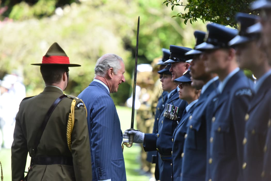 Prince Charles then inspected members of the armed forces lined up in the grounds of Government House.