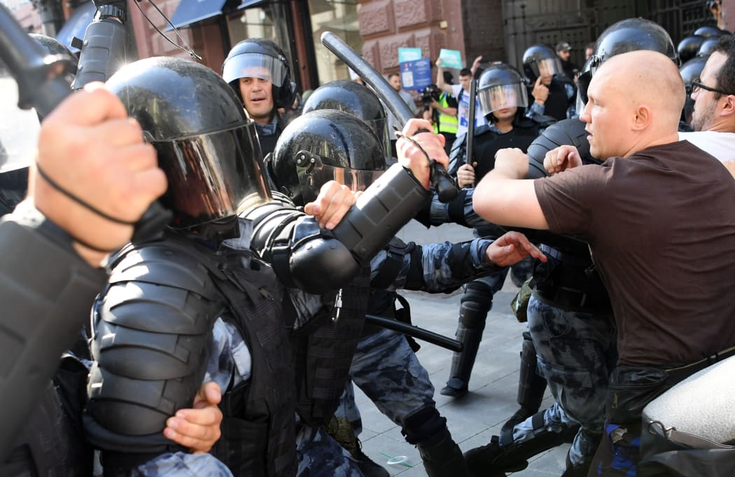 Protesters clash with riot police during an unauthorised rally demanding independent and opposition candidates be allowed to run for office in local election in September,