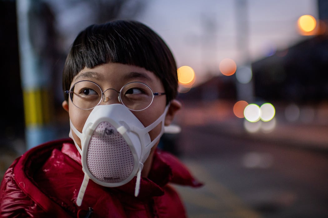 A child in Beijing, wearing a protective mask, 29 Janaury.
