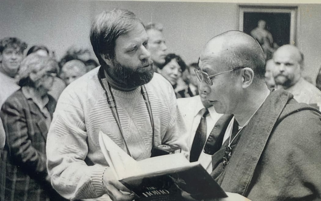 Dean hands the Dalai Lama a book on the hoiho
