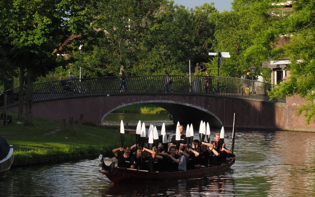 Strange juxtaposition: Dutch kaihoe (paddlers) train in the waka tētē Tāhimana on a canal in Leiden.