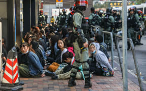 People are detained by police near the Hong Kong Polytechnic University in Hung Hom district of Hong Kong.