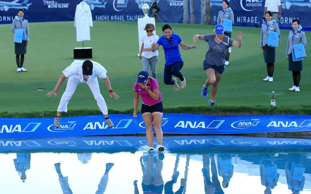 Lydia Ko celebrates her win at the ANA Inspiration with the winner's jump in the 18th lake alongside her caddie, mother and sister.