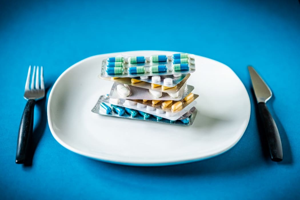 Capsules an pills in a plate. 
France (Photo by VOISIN / Phanie / Phanie via AFP)