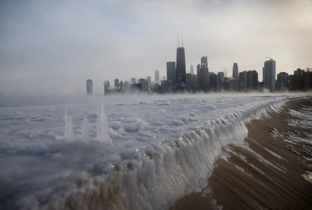 Ice builds up along Lake Michigan as temperatures in Chicago hit a record low.