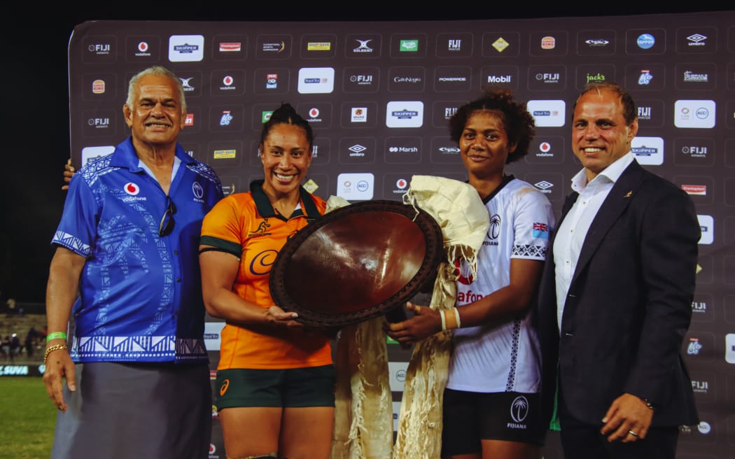 Wallaroos win - Wallaroos captain Sikapesi Palu ( second from left) and Fijiana captain Alfreda Smith, with the Vuvale Trophy flanker by Fiji Rugby board chairman John Sanday (left) and Australia Rugby chief Phil Waugh at the National Stadium in Suva on Saturday. Photo: FRU Media