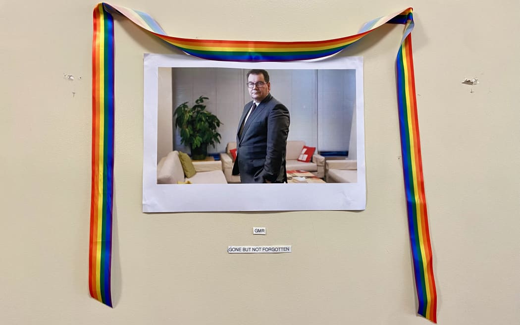 An improvised portrait of Grant Robertson, garlanded with a rainbow ribbon hangs outside the Labour Party corridor in Parliament House, in the spot where a portrait of Winston Churchill once hung. His colleagues have captioned it 
