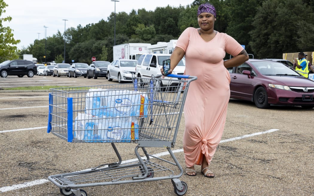 JACKSON, MS - AUGUST 31: Jamiya Williams is seen after picking up cases of bottled water at a Salvation Army of Jackson and Walmart distribution site at a Walmart on August 31, 2022 in Jackson, Mississippi. Jackson is experiencing a third day without reliable water service after river flooding caused the main treatment facility to fail. Late Tuesday night, President Joe Biden declared an emergency amid the crisis.   Brad Vest/Getty Images/AFP (Photo by Brad Vest / GETTY IMAGES NORTH AMERICA / Getty Images via AFP)