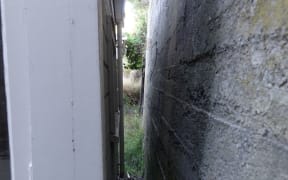 A retaining wall once 1.5 metres away moves to within a few centimetres of the house.