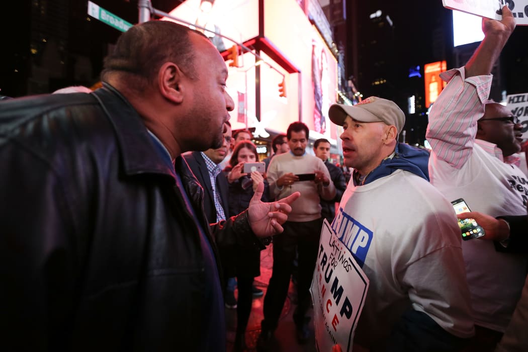 Donald Trump supporters and protestors argue in Times Square as they await election results on November 8, 2016 in New York City.