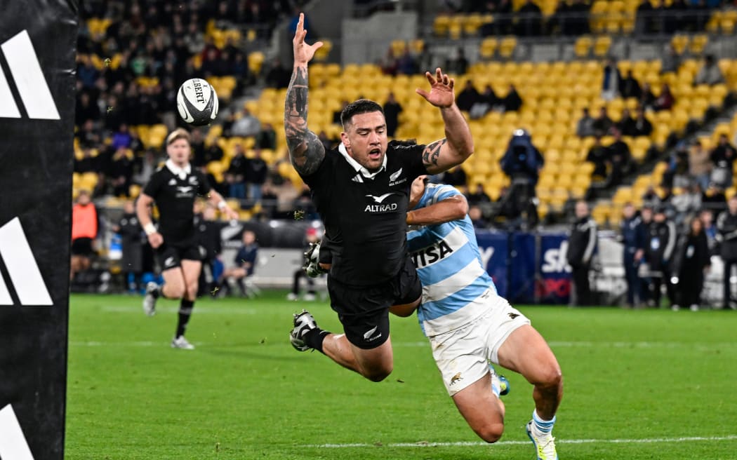 Vice Captain Codie Taylor of New Zealand dives as Matias Moroni of Argentina chases.