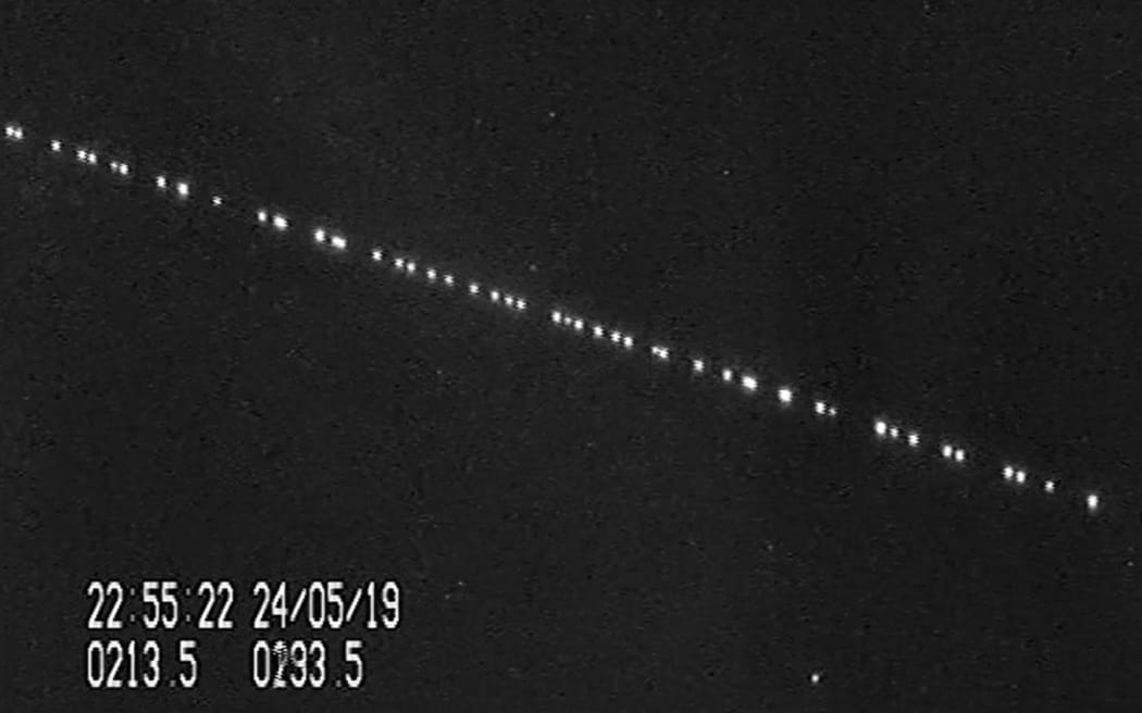 A screenshot from a video of SpaceX Starlink satellites passing over Leiden, Netherlands on 24 May, 2019.
