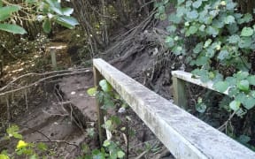 A damaged bridge near Houghton Valley Play Centre, Wellington, where a burst water main sent a torrent of mud and trees into the valley below.