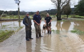 Sam Davis, centre, says three quarters of his Northland Dairy farm was underwater