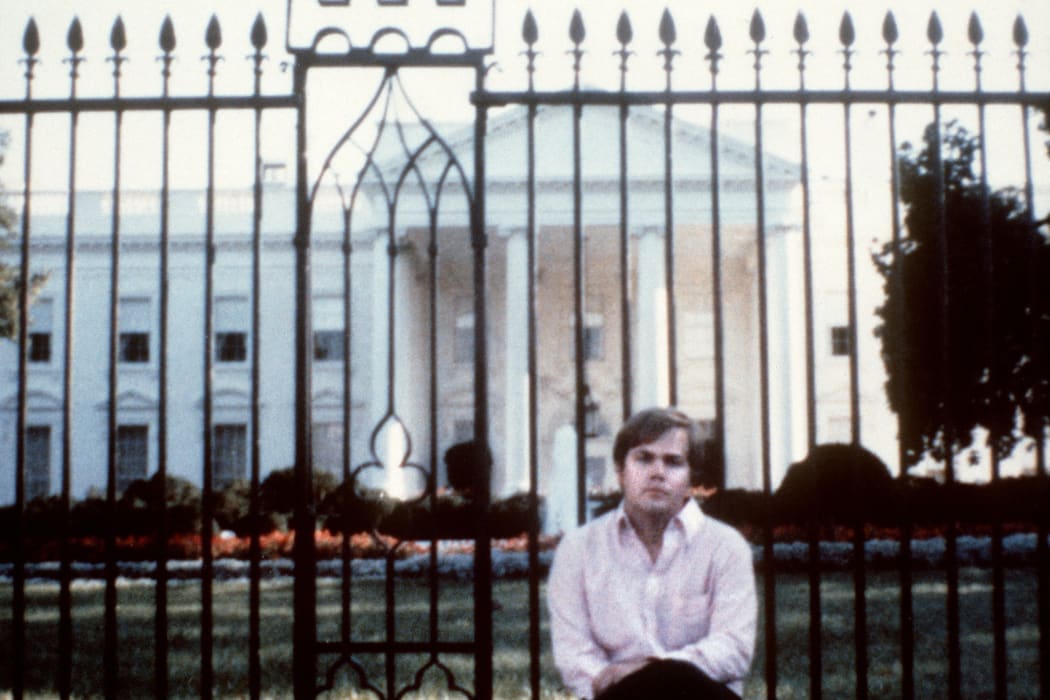 John Hinckley poses in front of the White House in March 1981. He attempted to assassinate US President Ronald Reagan in Washington DC a month later.