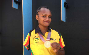Friana Kwevira with her gold medal
