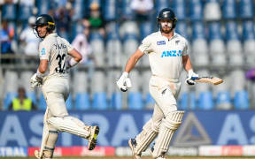New Zealand's Will Young (L) and Glenn Phillips run between the wickets during the second day of the third and final Test cricket match between India and New Zealand at the Wankhede Stadium in Mumbai on November 2, 2024. (Photo by INDRANIL MUKHERJEE / AFP) / -- IMAGE RESTRICTED TO EDITORIAL USE - STRICTLY NO COMMERCIAL USE --