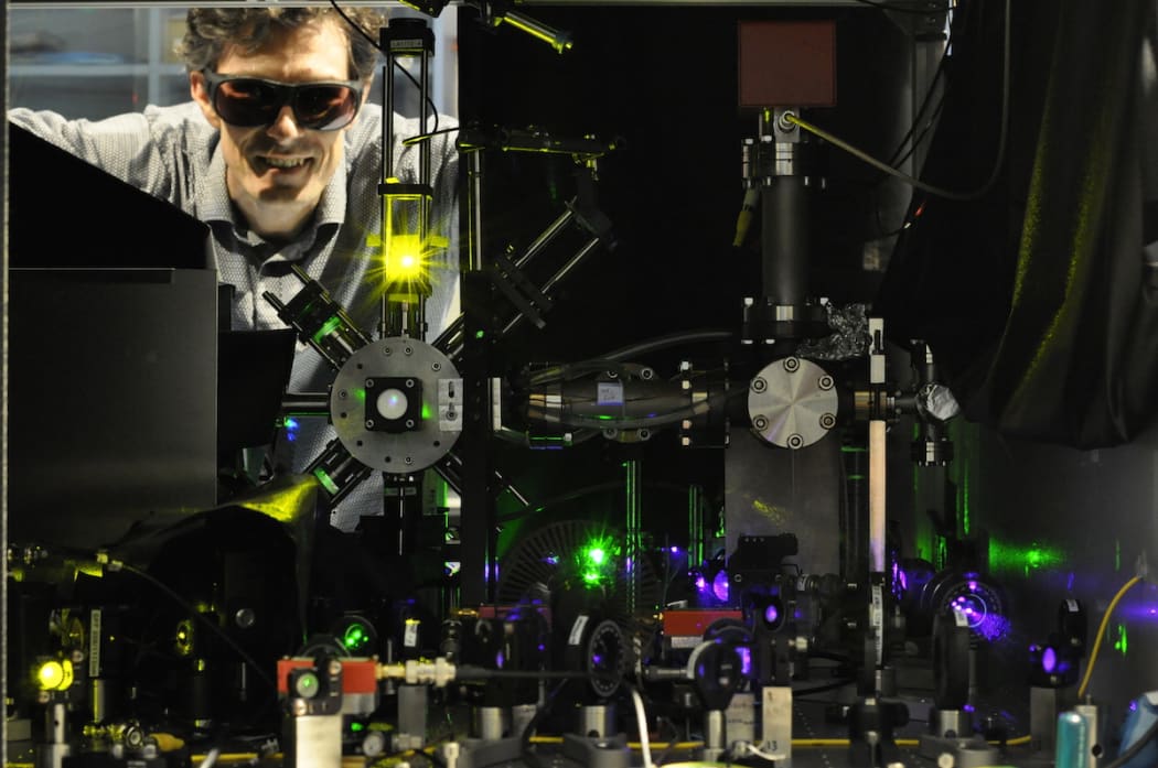 Professor John McFerran with an atomic clock.