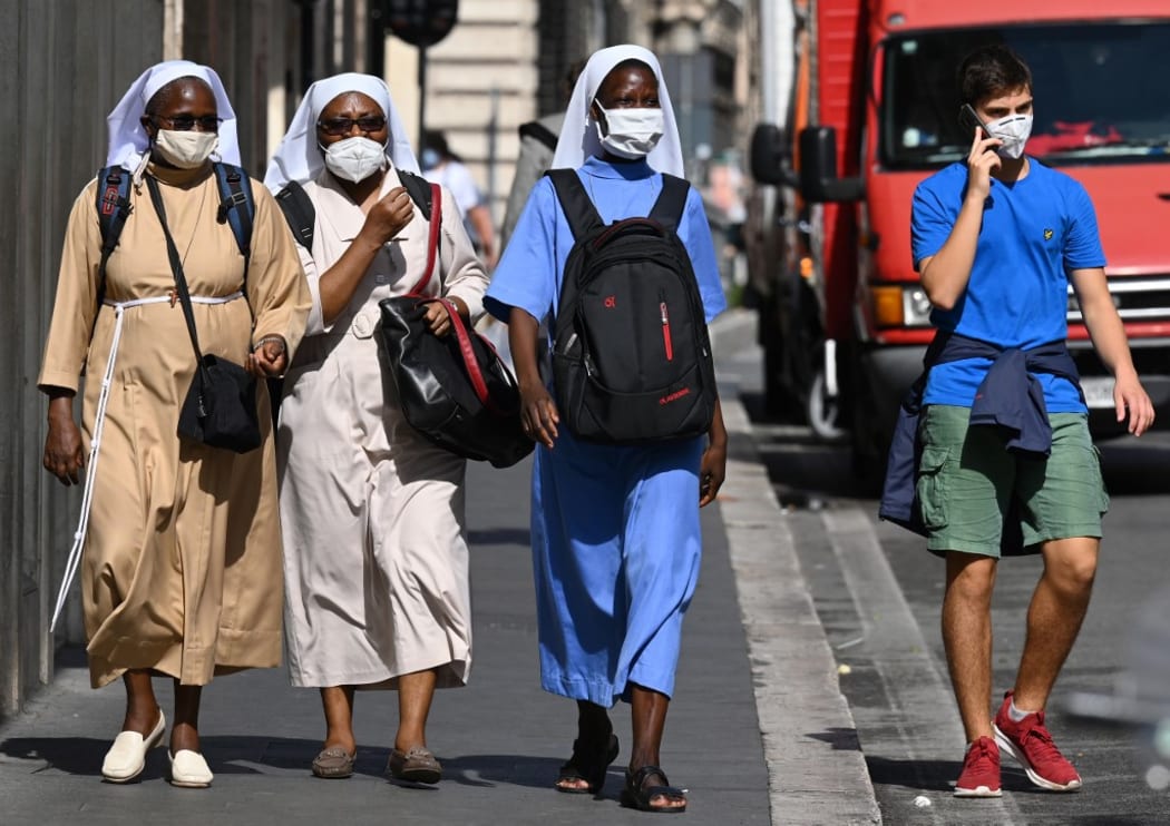 Nuns wearing a face mask walk along the Via del Corso main shopping street in downtown Rome on September 25, 2020 during the COVID-19 pandemic, caused by the novel coronavirus.
