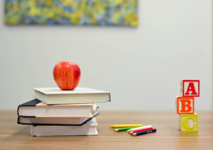 Apple, books, pencils and building blocks.