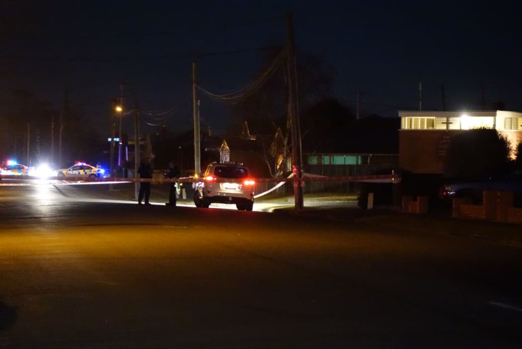 Police at the cordon set up around the house where the bodies were found.
