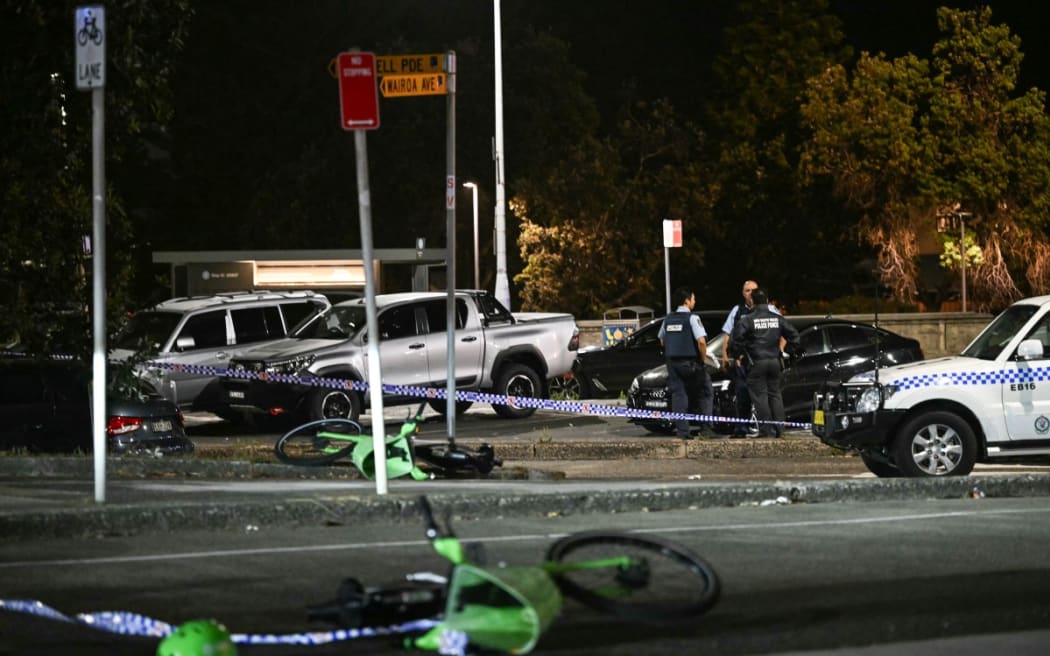 Police work at the scene after a shooting incident at Bondi Beach in Sydney on 14 December 2025. Two gunmen opened fire at Sydney's Bondi Beach on December 14, killing 11 people and wounding multiple others in a "terrorist incident" during a gathering for the Jewish festival of Hanukkah.