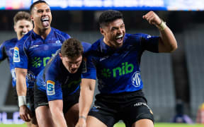 Blues winger Caleb Clarke celebrates a Rieko Ioane try.