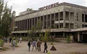 Visitors look in the abandoned city of Pripyat, near the Chernobyl nuclear power plant, Ukraine, on 7 June 2019.