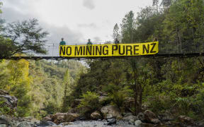 Forest & Bird and Forest & Bird Youth hung this banner off a bridge in Wharekirauponga, Coromandel Forest Park on 21 October to protest mining on conservation land.